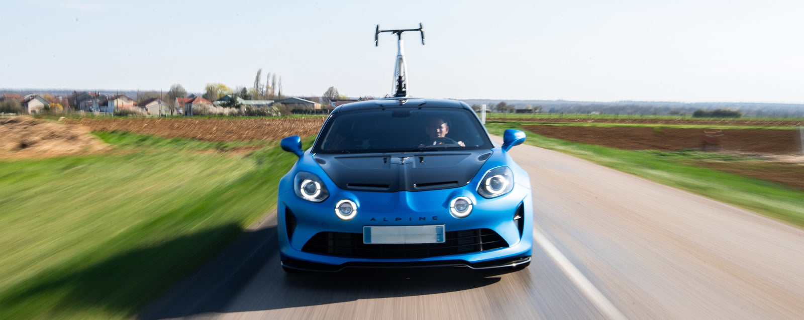 Blue Car Driving on Road in Countryside